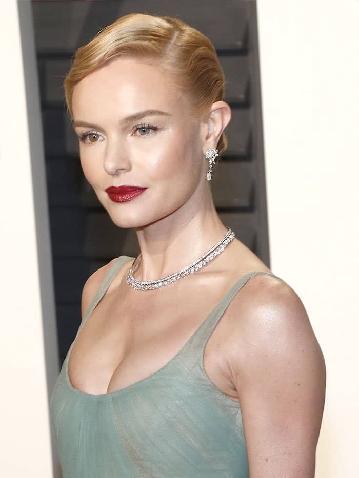 Kate Bosworth’s sleek finger wave updo perfectly complements her vintage-inspired look, while her Piaget diamond necklace adds a timeless touch of elegance