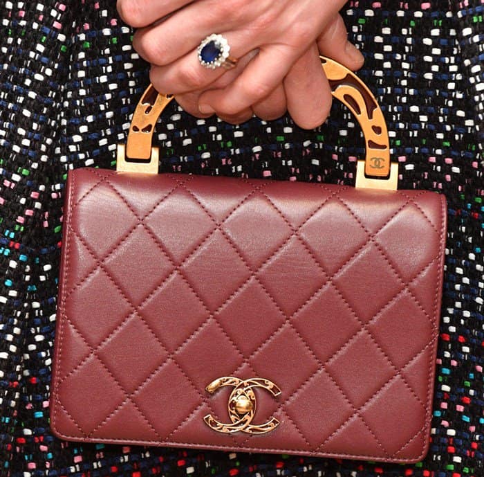 Kate Middleton showcased her iconic Garrard sapphire engagement ring alongside a luxurious burgundy Chanel flap bag with a gold enamel handle