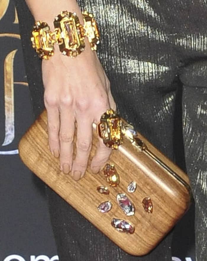 Louise Roe went a little eccentric by pairing metallic with a wooden clutch