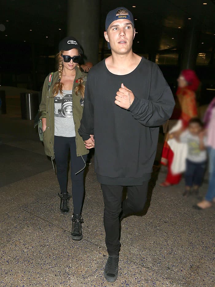 Paris Hilton holding hands with her boyfriend Chris Zylka as they arrive at the LAX airport in Los Angeles, California, on March 15, 2017.