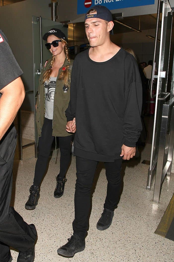 Paris Hilton holding hands with her boyfriend Chris Zylka as they arrive at the LAX airport in Los Angeles, California, on March 15, 2017.