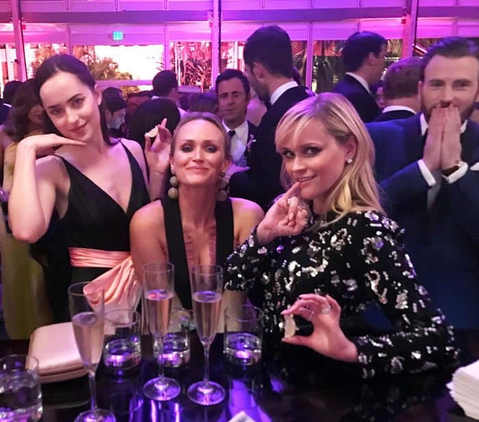 Reese and her friends Dakota Johnson and Emily Ward get photobombed by Chris Evans