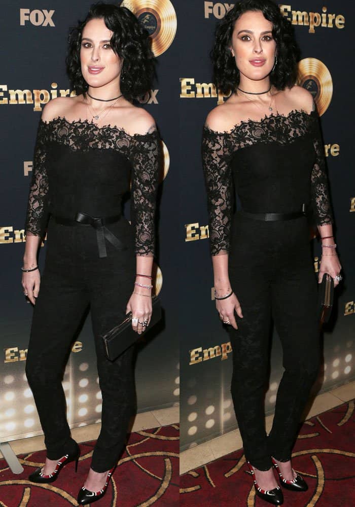 In a tasteful and chic black lace jumpsuit by Monique Lhuillier, Rumer Willis exudes a classic, understated elegance, perfectly balancing modern style with traditional grace at the event