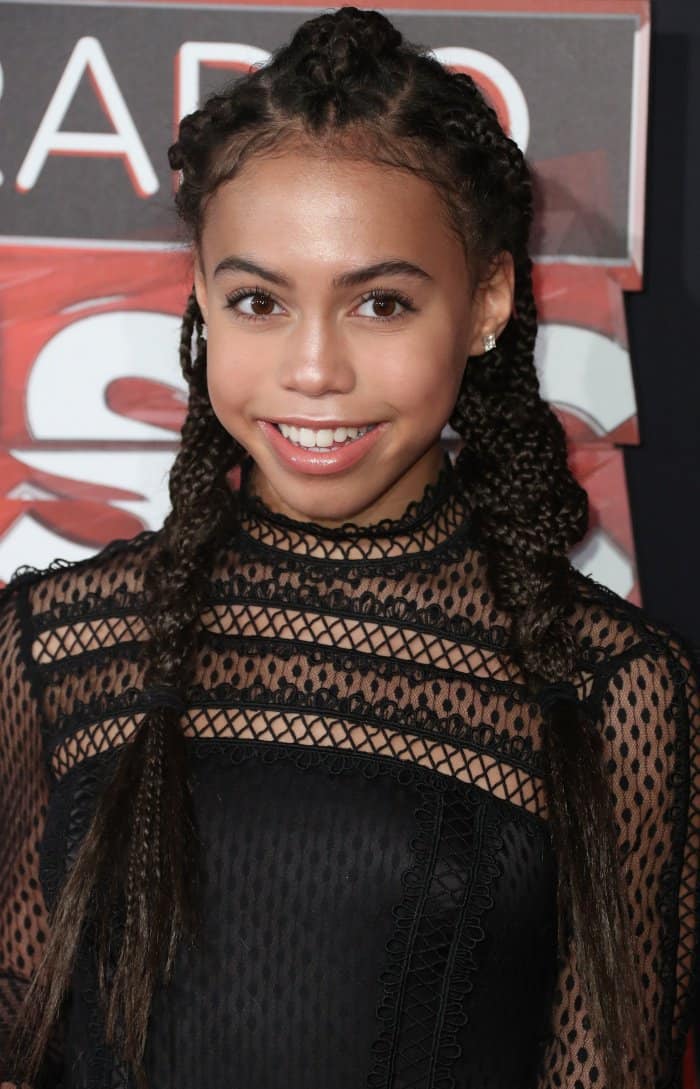 Asia Monet Ray styled her hair in two long braids to highlight her earrings and glossy lips