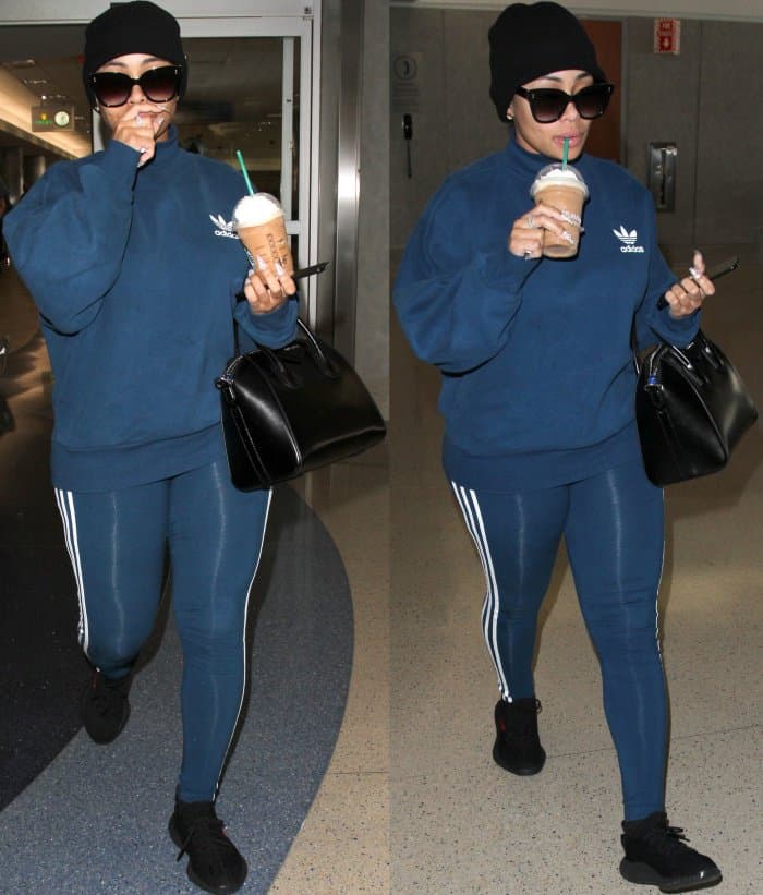 Blac Chyna styles a blue Adidas tracksuit with oversized sunglasses and a beanie cap