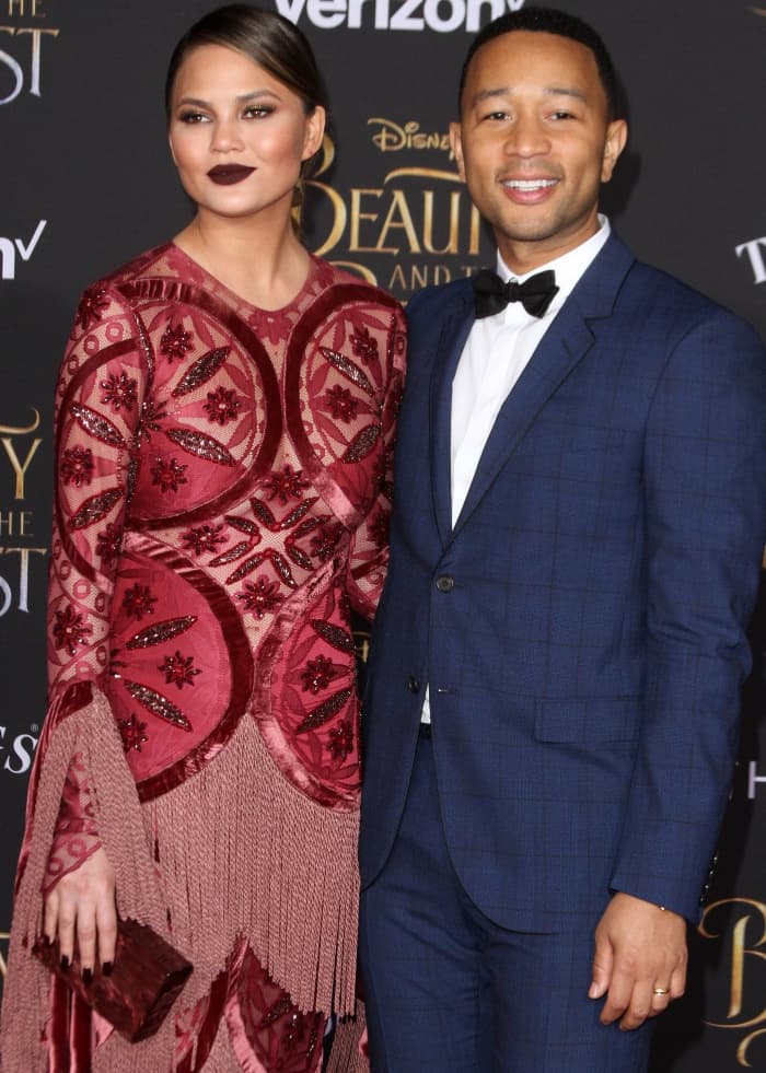 Chrissy Teigen wearing a Raisa & Vanessa gown and John Legend wearing a navy patterned tux