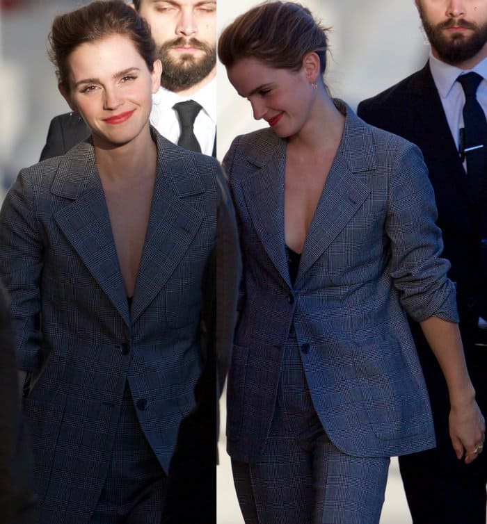 Emma Watson’s hair is styled in a chic, effortless updo with soft volume, complementing her sophisticated look