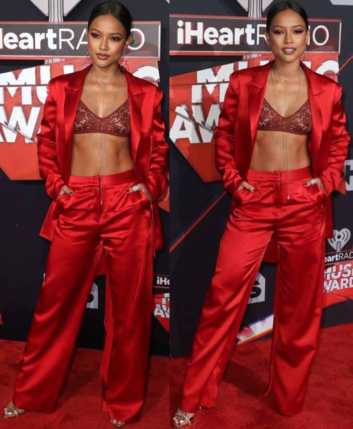 Karrueche Tran wearing a red satin Yousef Akbar two-piece suit at the 2017 iHeartRadio Music Awards