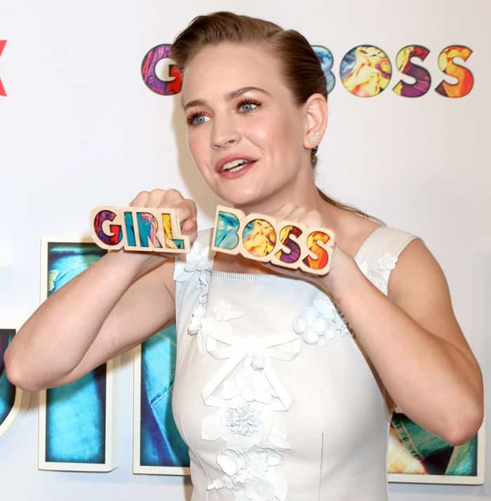 Britt shows her "Girlboss" knuckles to the photographers