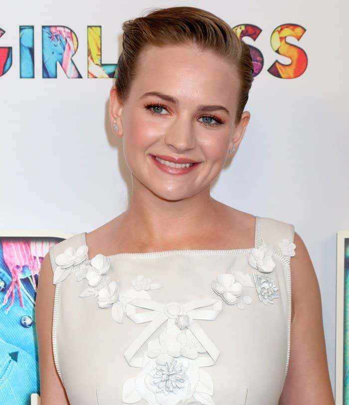 Britt Robertson styled her hair in a sleek, side-parted updo and complemented her look with soft, peach-toned makeup, featuring subtle smoky eyes and a glossy nude lip