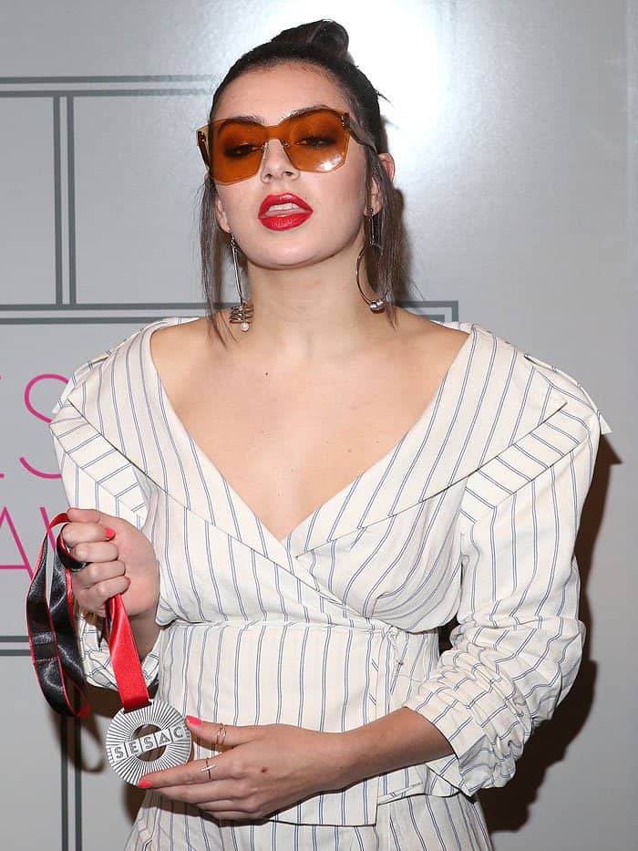 Charli XCX holding her Songwriter of the Year and Song of the Year awards that she won at the 2017 SESAC Pop Awards