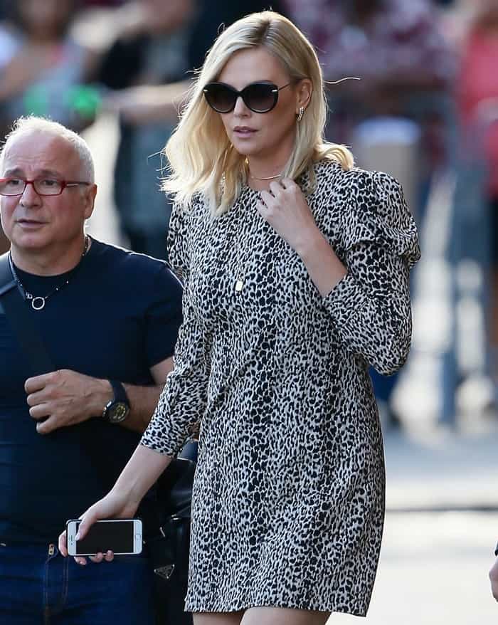 Charlize Theron wearing a puffed-sleeve leopard dress for an appearance on Jimmy Kimmel Live in Los Angeles on April 14, 2017