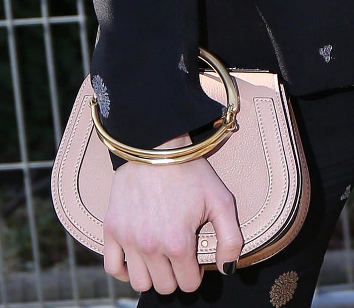 Emma carrying a Chloe Nile medium purse during fashion week