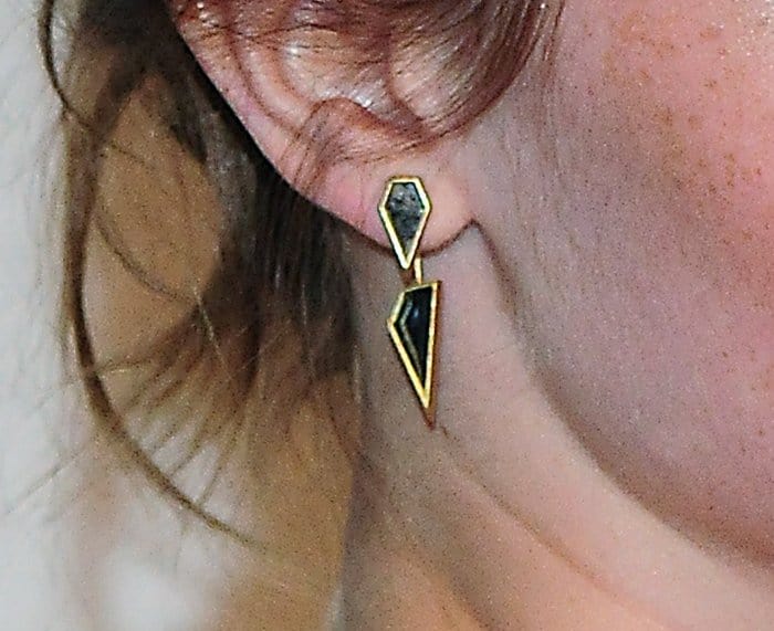 Emma Watson wearing unique Monique Péan fossilized dinosaur bone earrings