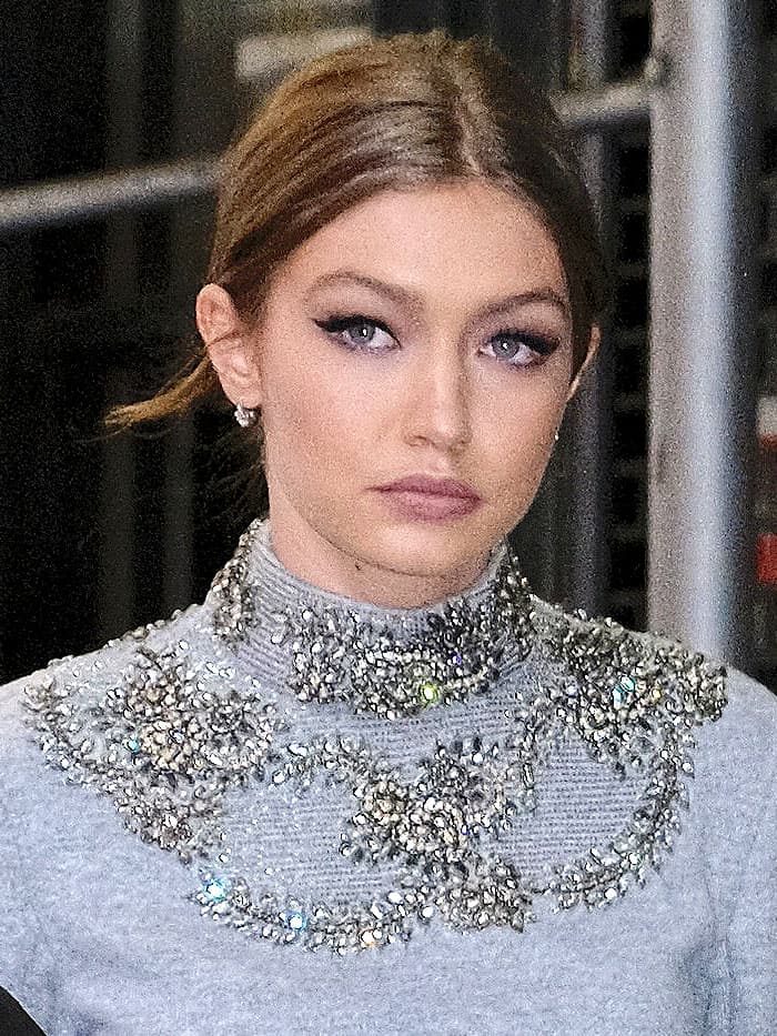 Gigi Hadid in gray embellished crop-top sweatpants leaving a building in SoHo in New York City on April 12, 2017.