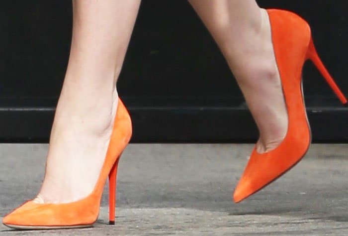 Katherine Heigl adds a pop of orange into her look with a pair of Christian Louboutin So Kate pumps