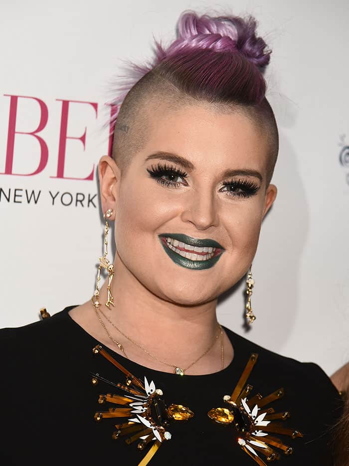 Kelly Osbourne completed her edgy look with gold skeleton earrings and a statement necklace adorned with striking amber-colored embellishments