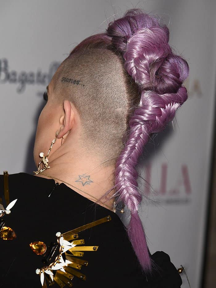 Kelly Osbourne rocking a purple braided mohawk with shaved sides.