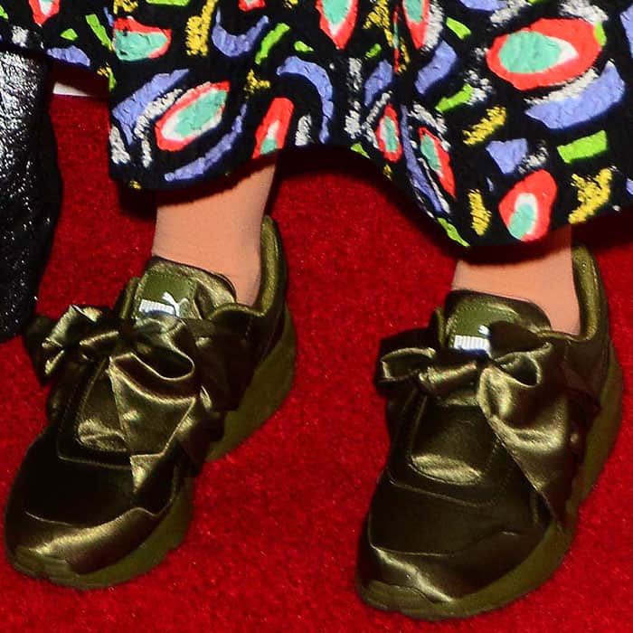 Closeups of the olive green Fenty Puma by Rihanna bow sneakers on Lena Dunham.