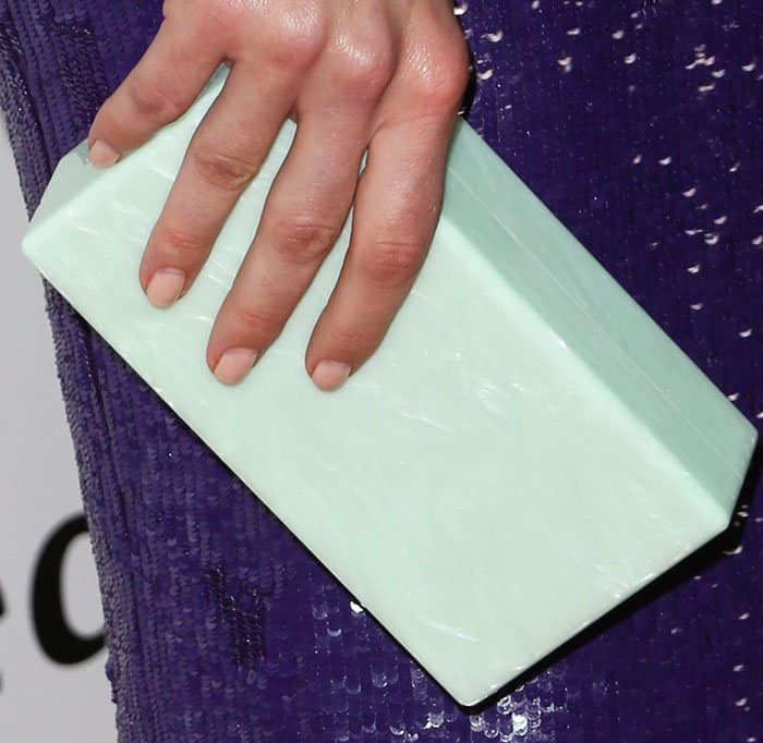 Mandy breaks the purple Jeffrey Dodd dress with a mint clutch by Edie Parker