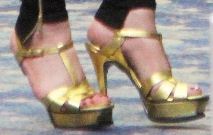 Mariah carried out her mom duties in a pair of gold Saint Laurent "Tribute" platform sandals