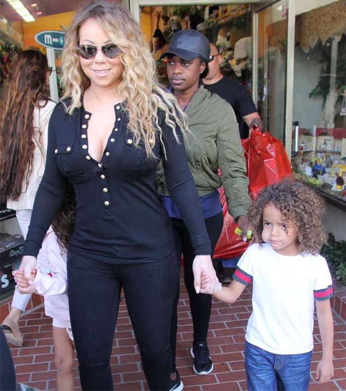 Mariah walks out of Tom's Toys with her two tikes in hand