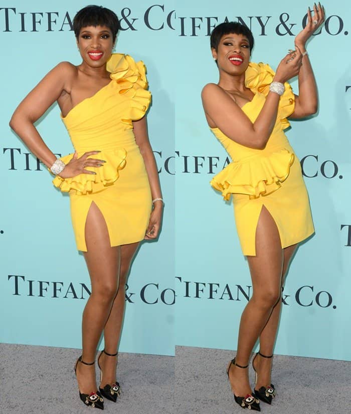 Jennifer Hudson turned heads at the Tiffany Blue Book Gala in a ruffled yellow DSquared2 mini dress, dazzling Tiffany & Co. diamond jewelry, and black satin platform heels adorned with jeweled floral accents