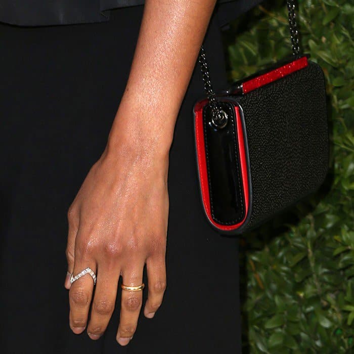 Zoe carrying Christian Louboutin’s 'Vanite' clutch