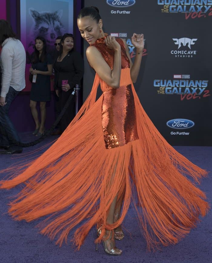 Zoe Saldaña twirls in a custom Emilio Pucci gown adorned with sequins and bold orange fringe at the Guardians of the Galaxy Vol. 2 world premiere