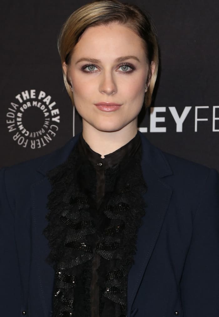 Leaving the suit unbuttoned, Evan Rachel Wood showcased a black lacey affair, adding a touch of allure to her ensemble