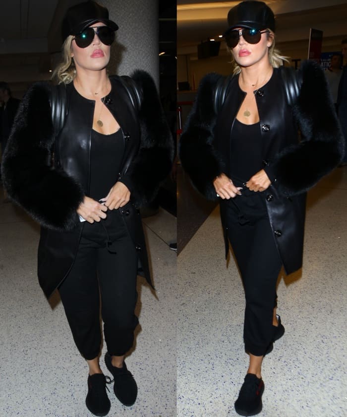 Khloe Kardashian wearing an all-black outfit styled with Yeezy Boost 350 V2 Sneakers at LAX