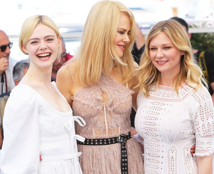 Elle Fanning shows off her trademark smile alongside castmates Nicole Kidman and Kirsten Dunst