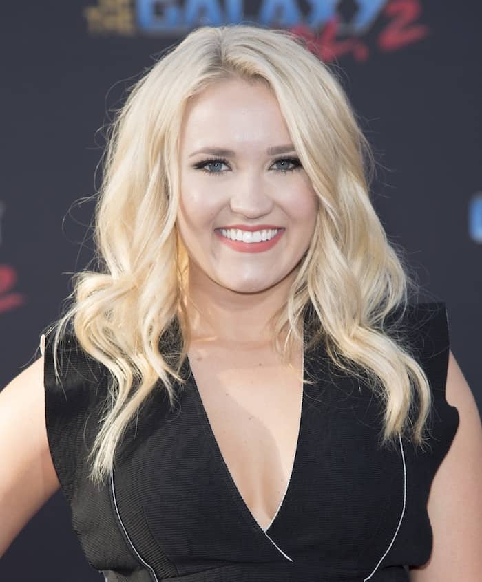 Emily Osment completed her look with bold eyes and lips and her hair in gorgeous waves