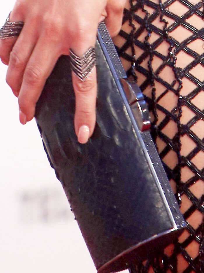 J.Lo adds an interesting touch to her look with a reptile embossed clutch by Jimmy Choo