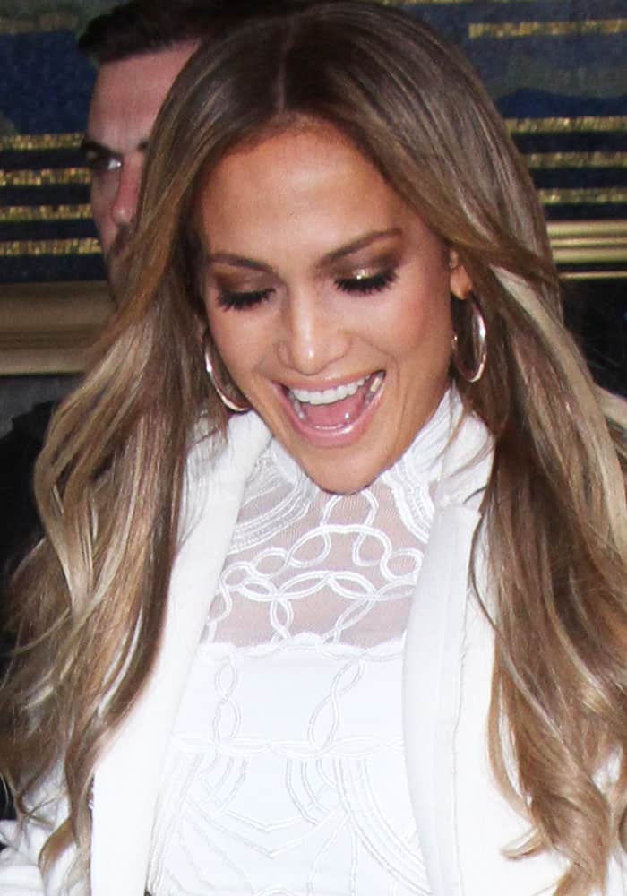 Jennifer Lopez at 30 Rock NBC Studios on May 8, 2017, wearing a white Jonathan Simkhai dress underneath a long midi jacket, accessorized with hoop earrings