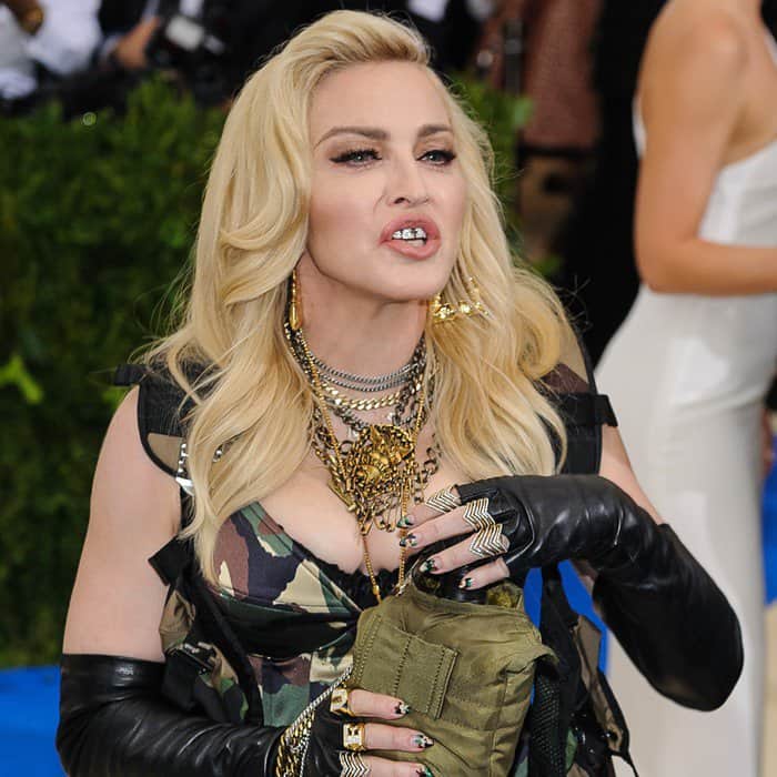 Madonna flashed a diamond grill on her teeth, styled her platinum blonde hair in soft retro waves, and sported a bold camouflage-inspired manicure at the 2017 Met Gala