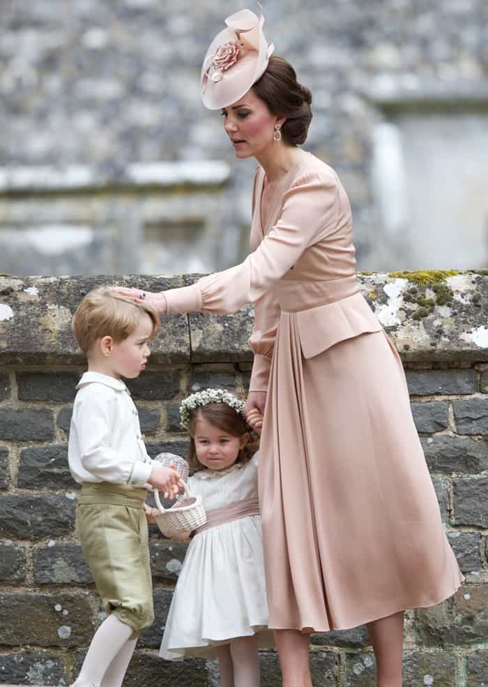 Kate Middleton, in a dusty pink Alexander McQueen dress, tends to Prince George and Princess Charlotte as they perform their duties as pageboy and bridesmaid at Pippa Middleton's wedding