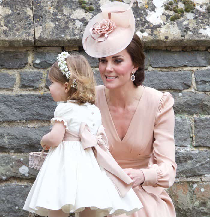 Kate Middleton radiates elegance in a dusty pink Alexander McQueen dress while doting on Princess Charlotte at Pippa Middleton's wedding