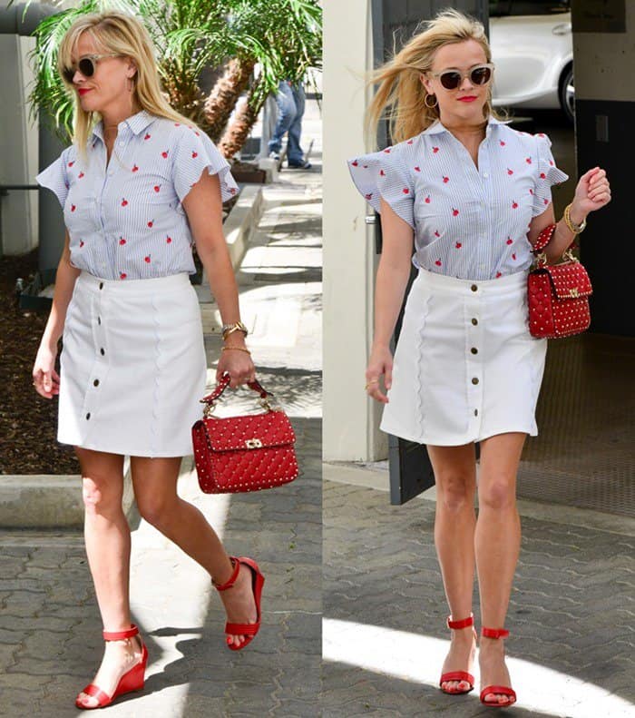 Reese Witherspoon channels effortless summer chic in red Manolo Blahnik wedge sandals, a white button-front skirt, and a heart-print Draper James blouse while leaving her Beverly Hills office on April 27, 2017