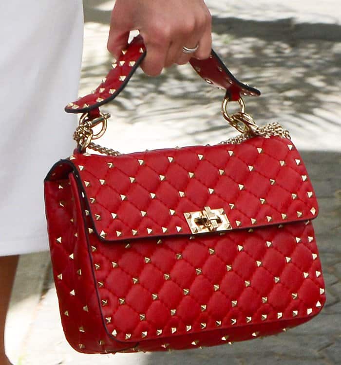 Pyramid-shaped gold studs add edgy elegance to this bold red quilted leather Valentino Rockstud Spike bag, a luxurious statement piece with timeless appeal