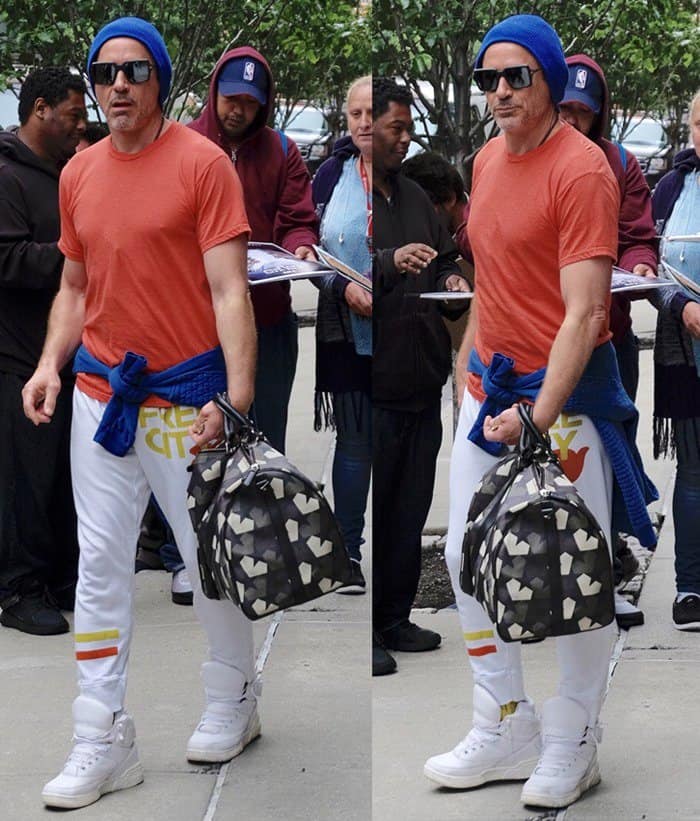 Robert Downey Jr. wore a blue beanie, an orange shirt, white sweatpants and white hi-top rubber shoes