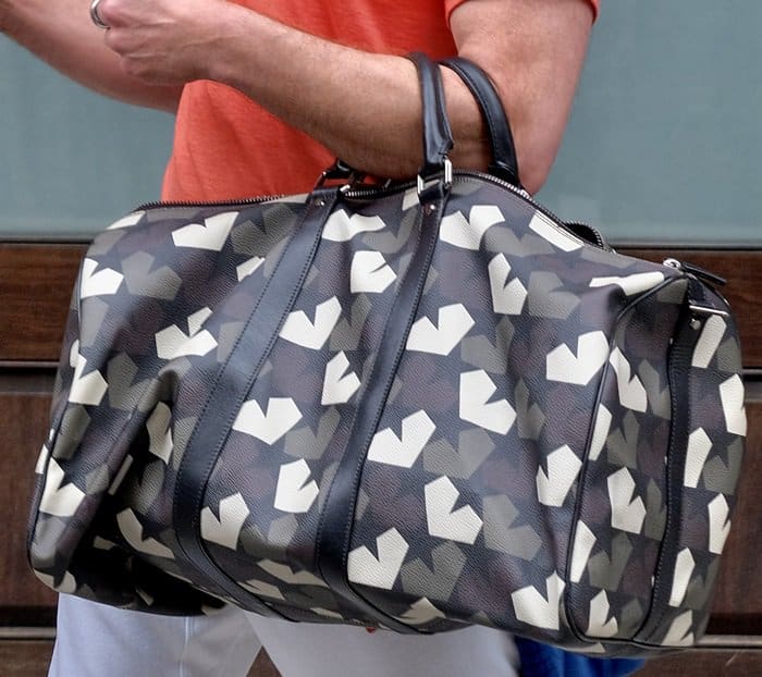 Robert signed autographs for his fans while carrying a Ports 1961 camouflage bag