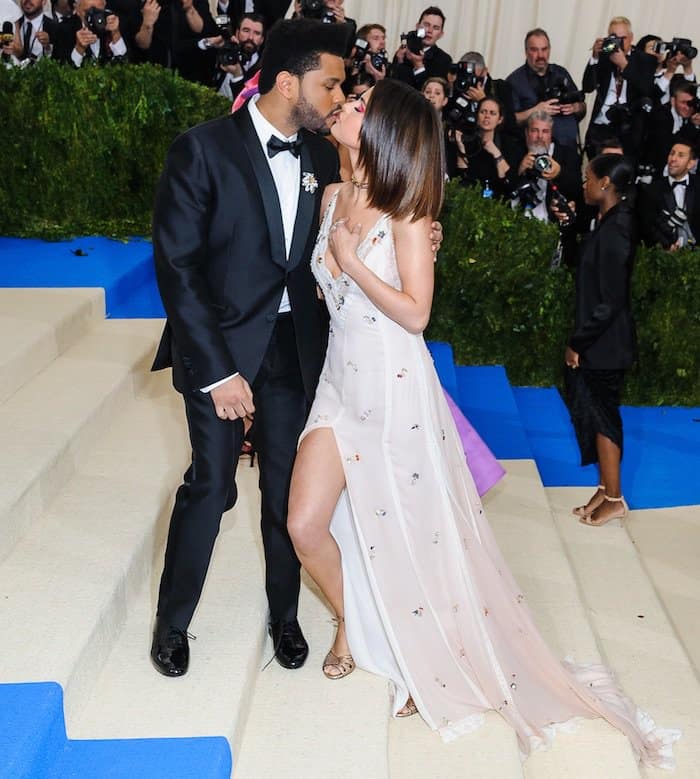 Selena Gomez showers The Weeknd with affection in a custom Coach gown for the MET Gala on May 1, 2017 at the Metropolitan Museum of Art in New York City