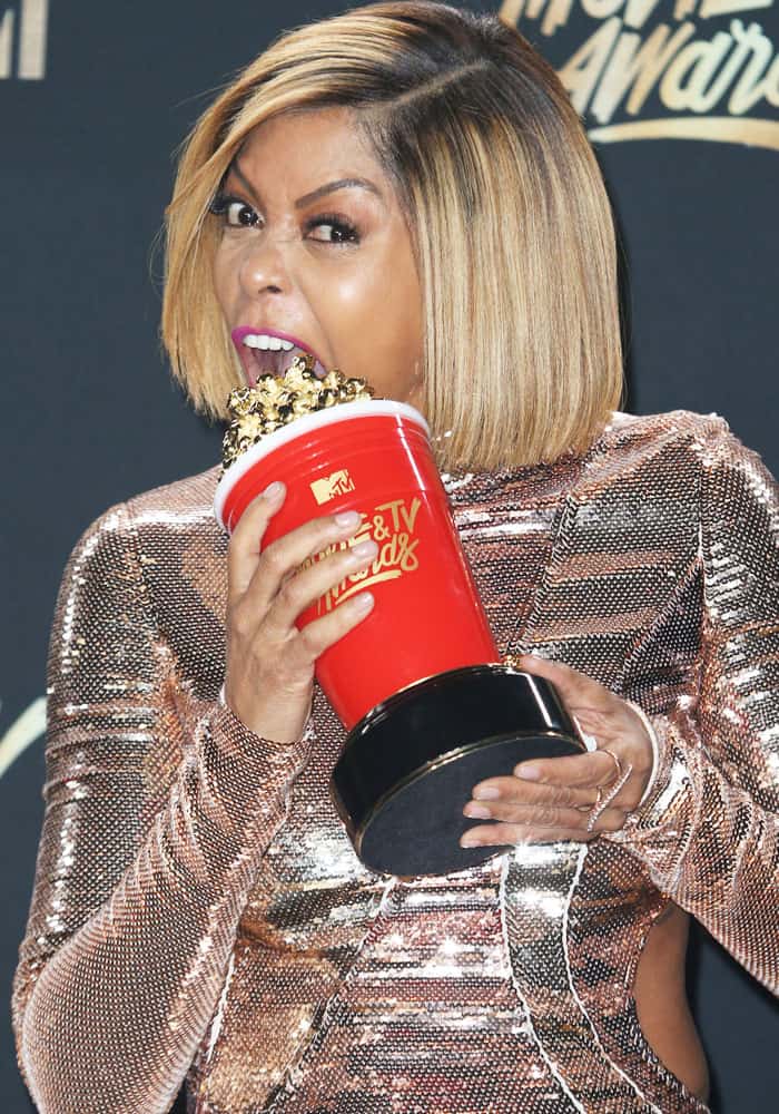 Taraji bites into her popcorn award for "Best Fight Against the System"