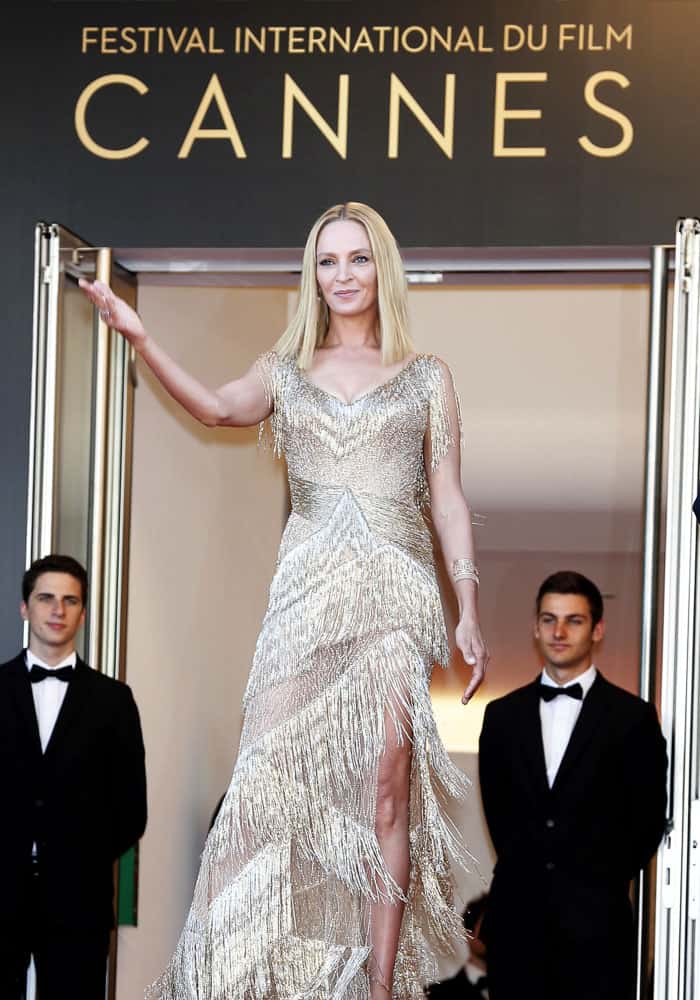 Uma greets the crowd from the top of the infamous carpeted stairs at the Palais des Festivals