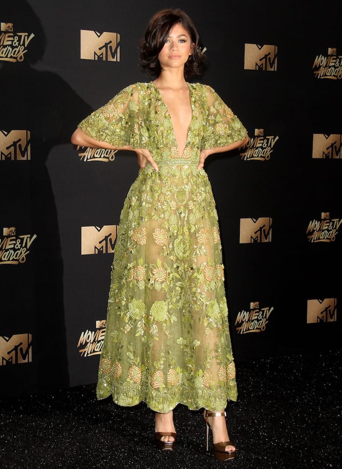 Zendaya dazzles at the MTV Movie & TV Awards in a sheer, floral-embellished Zuhair Murad dress paired with bronze Le Silla platform sandals