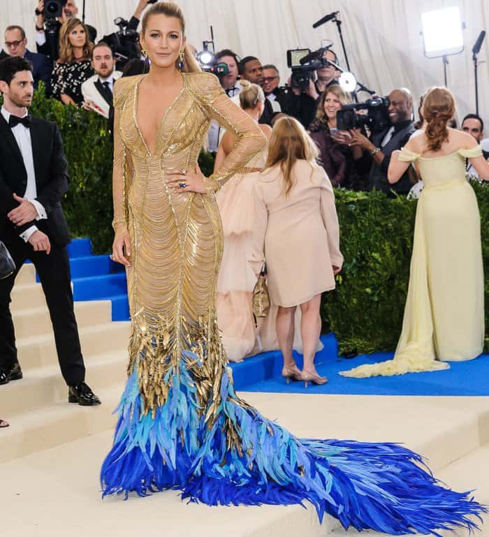 Blake Lively lit up the 2017 Met Gala red carpet in a sculpted gold Atelier Versace gown with intricate beadwork and a breathtaking feathered train that echoed the event’s avant-garde spirit
