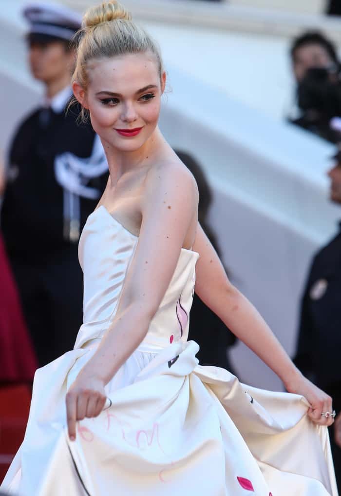 Elle Fanning wearing a custom Vivienne Westwood ball gown and Christian Louboutin shoes at the 70th Cannes Film Festival "Ismael's Ghosts" premiere
