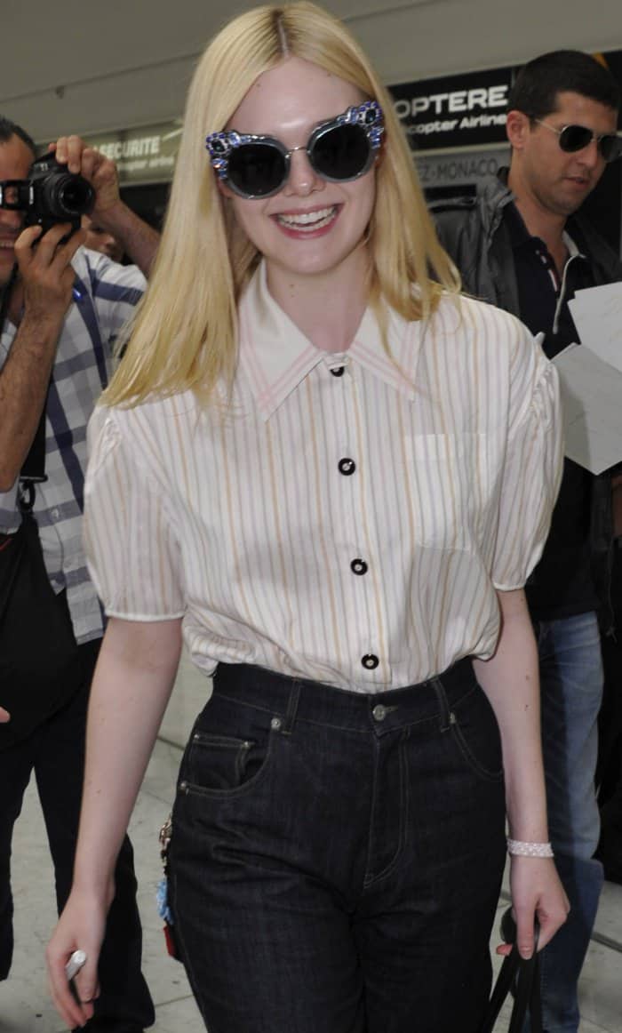 Elle Fanning wearing a Miu Miu ensemble and black slingback pumps at the Nice Cote d'Azur Airport