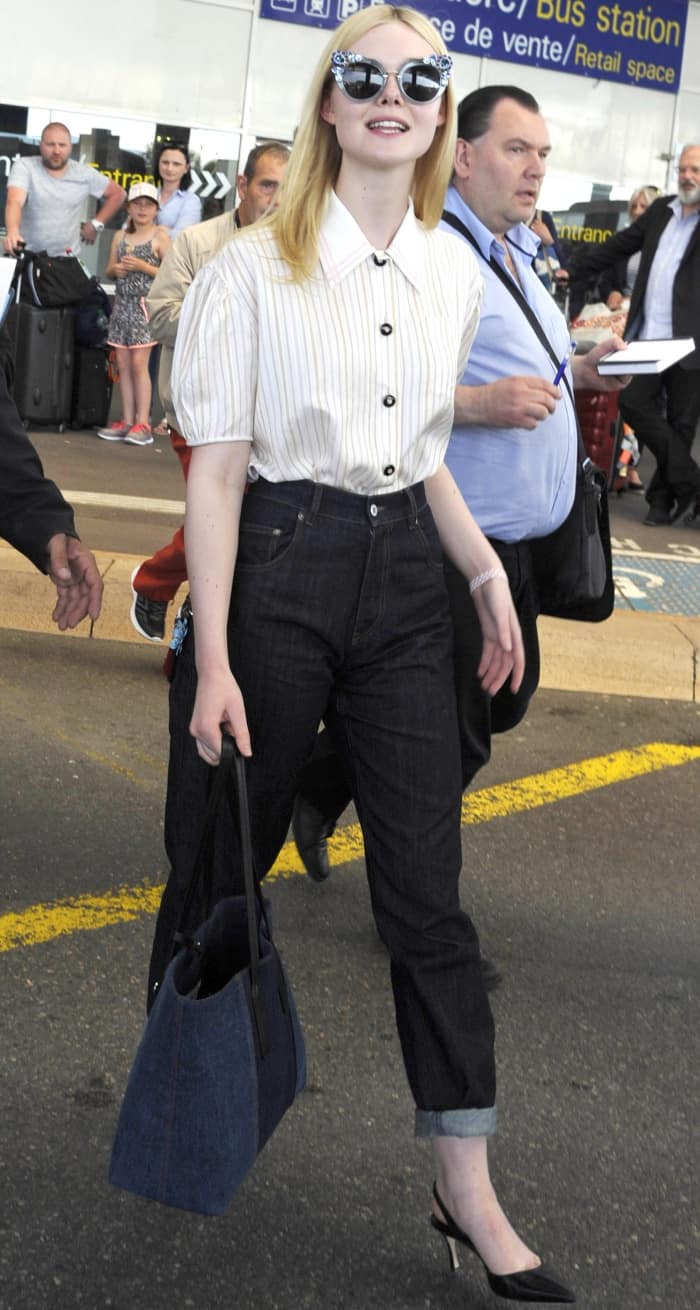 Elle Fanning wearing a Miu Miu ensemble and black slingback pumps at the Nice Cote d'Azur Airport